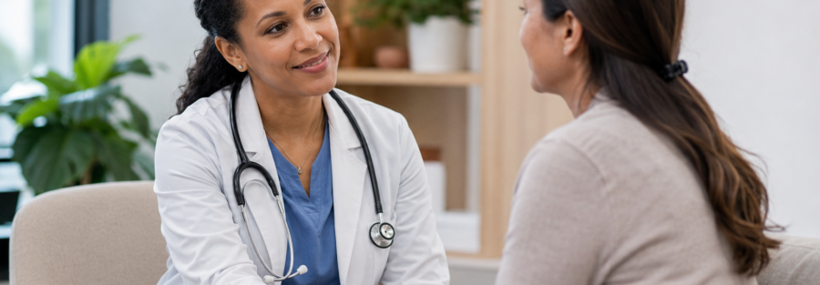 Compassionate healthcare provider holding a patient’s hands during a supportive consultation in a modern medical office.